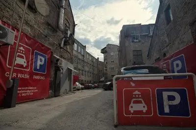 a parking sign on a street with a car on it at HostGost Selected Suites - Molerova 9 in Belgrade