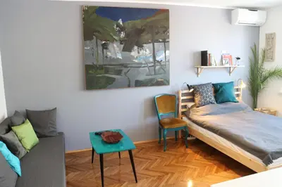 a living room with a bed and a couch at Atelier 22 in Belgrade