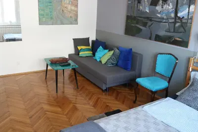 a living room with a couch and a chair at Atelier 22 in Belgrade