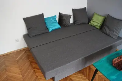 a couch with pillows on top of a room at Atelier 22 in Belgrade
