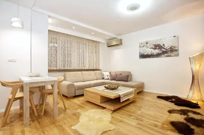 a living room with a couch and a table at HostGost Selected Suites - Skadarlija Square in Belgrade