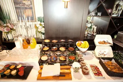 a table with a bunch of different types of pastries at HostGost Selected Suites - Skadarlija Square in Belgrade