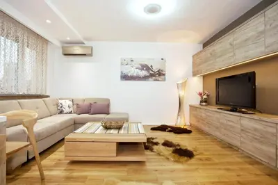 a living room with a couch and a tv at HostGost Selected Suites - Skadarlija Square in Belgrade