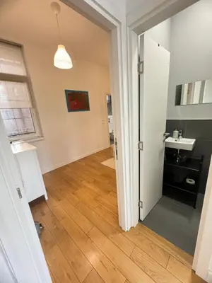 an open door to a room with a kitchen and a sink at Downtown Apartment in Belgrade