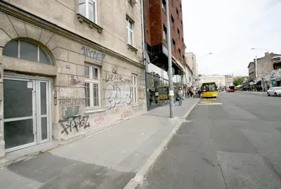 a street with graffiti on the side of a building at Downtown Apartment in Belgrade
