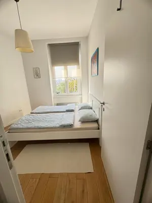 a bedroom with a bed and a window at Downtown Apartment in Belgrade