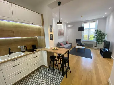 a kitchen and living room with a table and chairs at Downtown Apartment in Belgrade