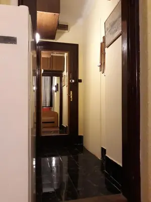 a hallway with a door and a mirror in a room at Garden studio in Belgrade
