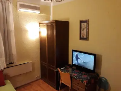 a room with a desk with a television on a table at Garden studio in Belgrade