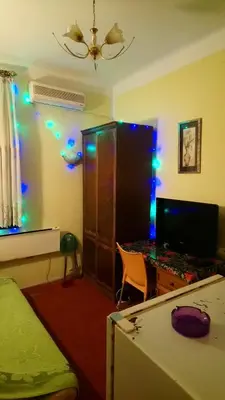 a room with a bed and a desk with lights at Garden studio in Belgrade