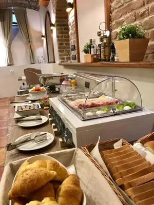 a buffet with bread and other food on a counter at M House Belgrade Residence in Belgrade