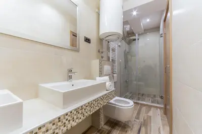 a bathroom with a sink and a toilet and a shower at M House Belgrade Residence in Belgrade