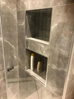 a bathroom with a shower with a glass wall at Apartman Oslo in Belgrade