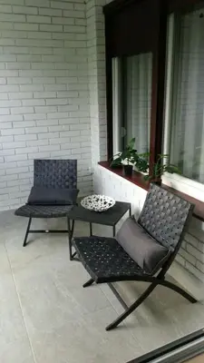 two chairs and a table on a porch at Apartman Oslo in Belgrade