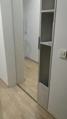 an empty refrigerator with a mirror in a room at Apartman Oslo in Belgrade
