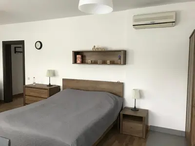 a bedroom with a bed and two night stands at Grocka Apartmani & rooms in Grocka