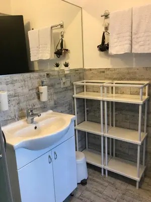 a bathroom with a sink and a toilet at Grocka Apartmani & rooms in Grocka