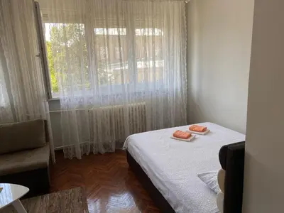 a small bedroom with a bed and a window at Apartment Dada Center of Belgrade in Belgrade