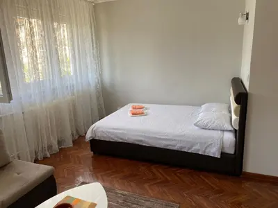 a small bedroom with a bed and a window at Apartment Dada Center of Belgrade in Belgrade