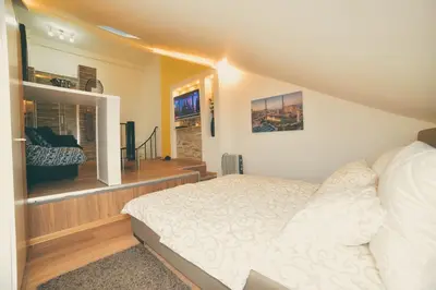 a bedroom with a bed and a large window at Apartman Las Vegas in Belgrade
