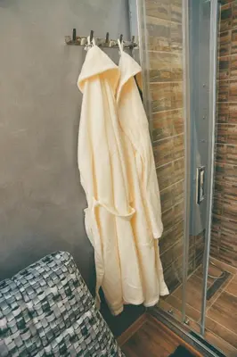 a robe hanging on a rack in a room at Apartman Las Vegas in Belgrade