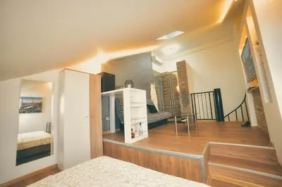 a room with a staircase and a bed in a room at Apartman Las Vegas in Belgrade