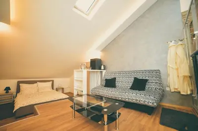 a living room with a couch and a glass table at Apartman Las Vegas in Belgrade