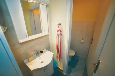 a bathroom with a sink and a toilet and a mirror at Apartman Las Vegas in Belgrade