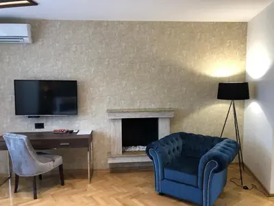 a living room with a couch and a fireplace at Aria Royal apartment in Belgrade