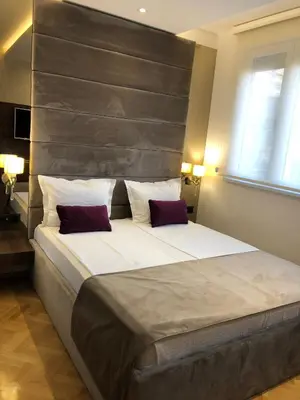a bedroom with a large bed with two pillows at Aria Royal apartment in Belgrade