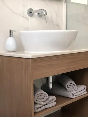 a bathroom with a sink and towels under it at Aria Royal apartment in Belgrade