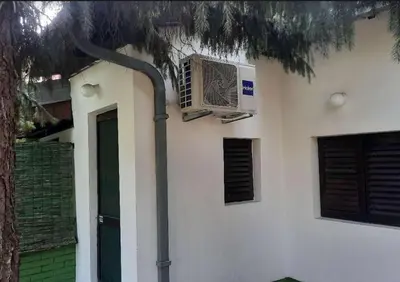a building with a air conditioner on the side of it at Šumska kuća Atina - Devojački Bunar in Alibunar