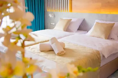 two beds in a hotel room with towels on them at Hotel Nota in Belgrade