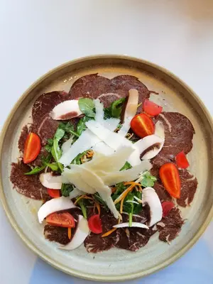 a plate of food with vegetables on a table at Hotel Nota in Belgrade