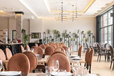 a dining room with tables and chairs at Hotel Nota in Belgrade