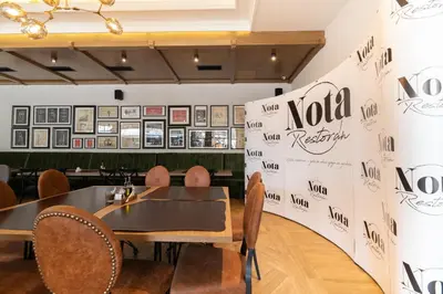 a dining room with a table and chairs at Hotel Nota in Belgrade