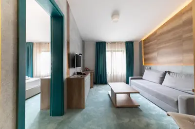 a living room with a couch and a television at Hotel Nota in Belgrade