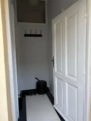 a white door in a room with a pot at Oaza 26 in Belgrade