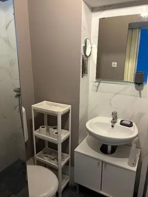 a white bathroom with a sink and a toilet at Oaza 26 in Belgrade