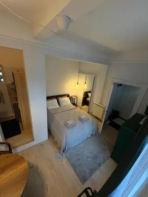 a bedroom with a large bed and a table at Oaza 26 in Belgrade