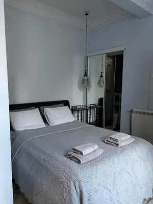 a bedroom with a bed with two towels on it at Oaza 26 in Belgrade
