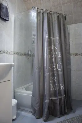 a bathroom with a shower curtain with the words learn to live in one mile at Dolce Casa in Belgrade