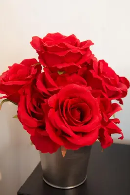 a bunch of red roses in a silver vase at Dolce Casa in Belgrade