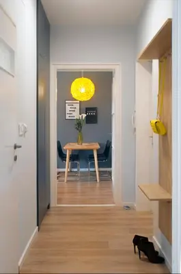 a hallway with a table and a yellow light at Victor Residence in Belgrade