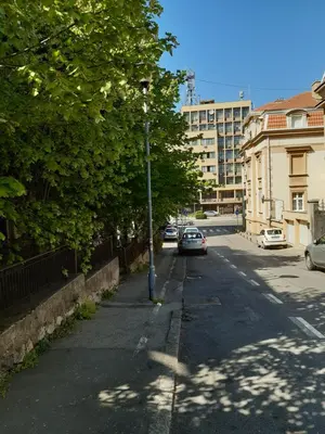 a street with cars parked on the side of the road at Victor Residence in Belgrade