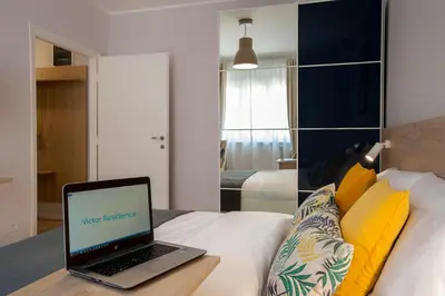 a laptop computer sitting on top of a bed at Victor Residence in Belgrade