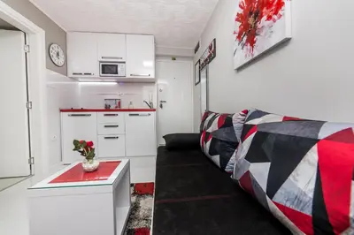 a living room with a couch and a kitchen at Apartment Romanov in Belgrade