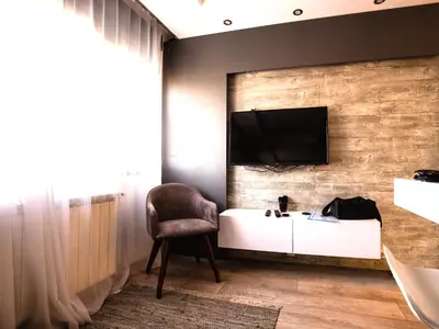 a living room with a tv on a brick wall at Luxury Boutique City Center Apartments in Belgrade