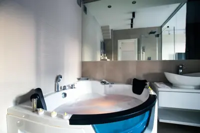 a bathroom with a bath tub and a sink at Luxury Boutique City Center Apartments in Belgrade