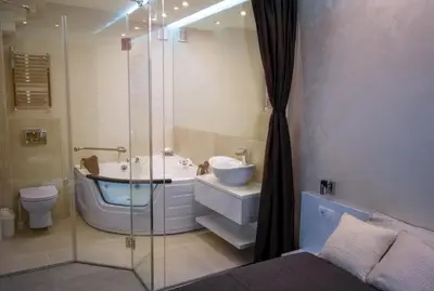 a bathroom with a tub and a sink and a shower at Luxury Boutique City Center Apartments in Belgrade